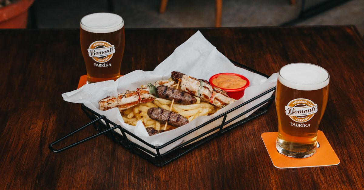 A table with drinks and shared plates of food