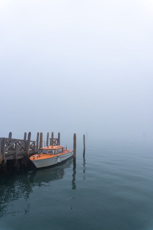 A Motorboat Moored to a Pier 