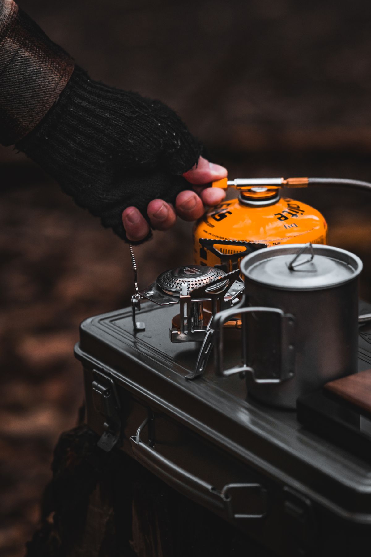 Outdoor camping kitchen with stove, pot and mug