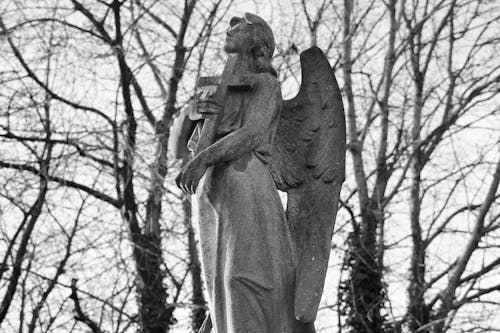A black and white photo of an angel statue