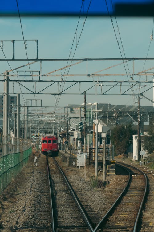 A train is traveling down a track with wires