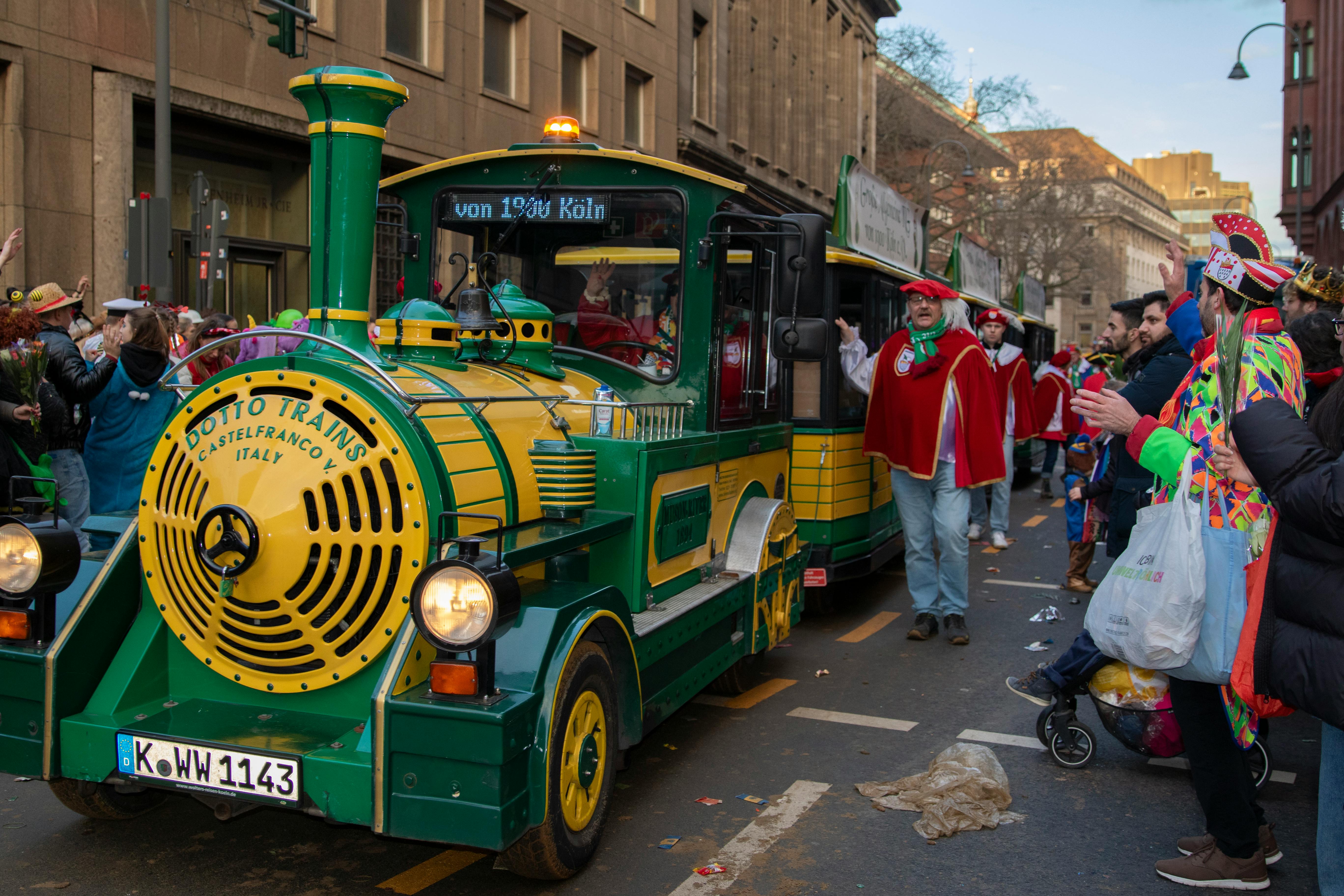 Festive scenes at the Cologne Carnival with vibrant costumes and parade train.