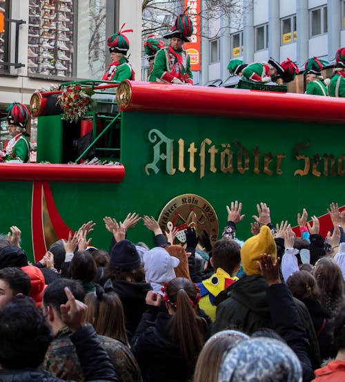 A parade float with people waving and waving