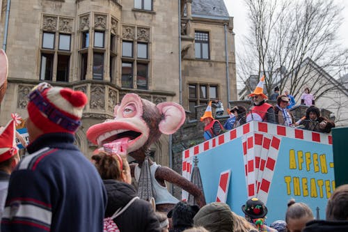 A float with a clown on it and people watching