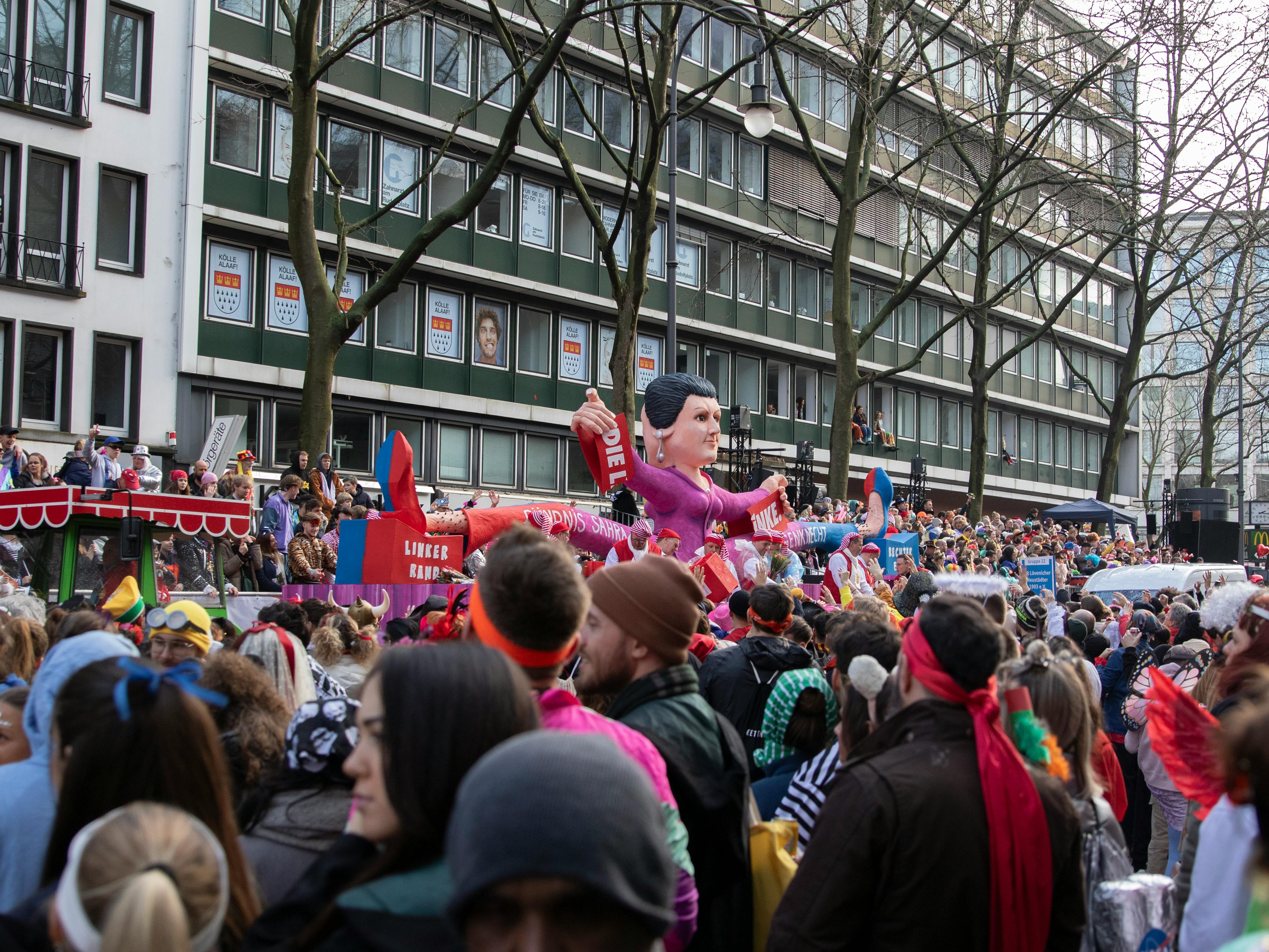 Festive carnival parade in Cologne with colorful floats, costumes, and a lively crowd.