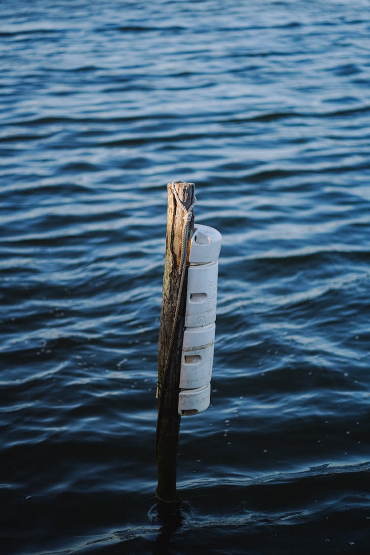 Blue, Wavy Water Behind Wooden Post