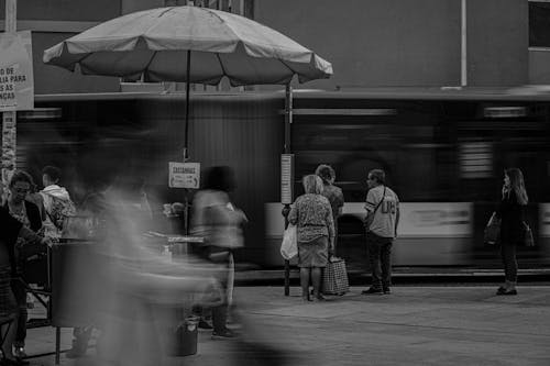 Passengers Wait on Bus Stop in City