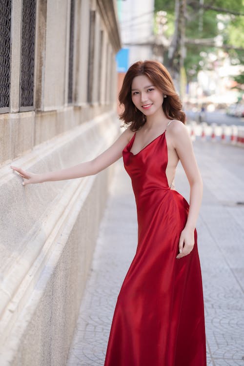 A woman in a red dress posing for a photo