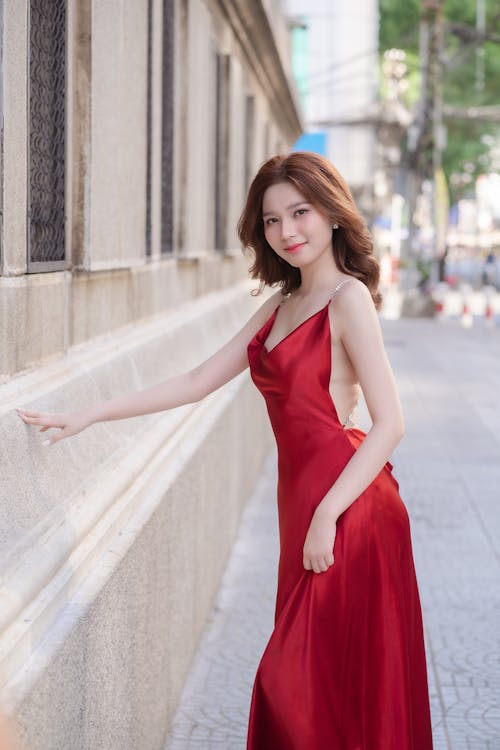 A woman in a red dress posing for a photo