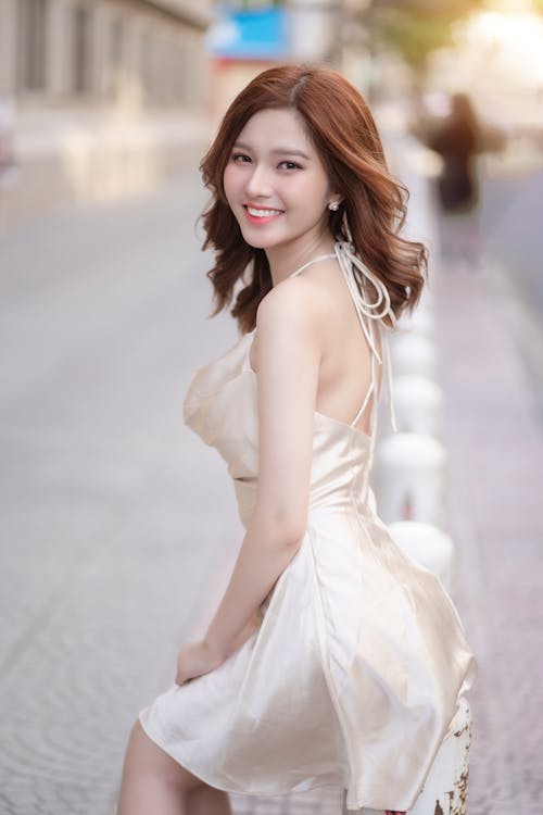 A beautiful asian woman in a white dress