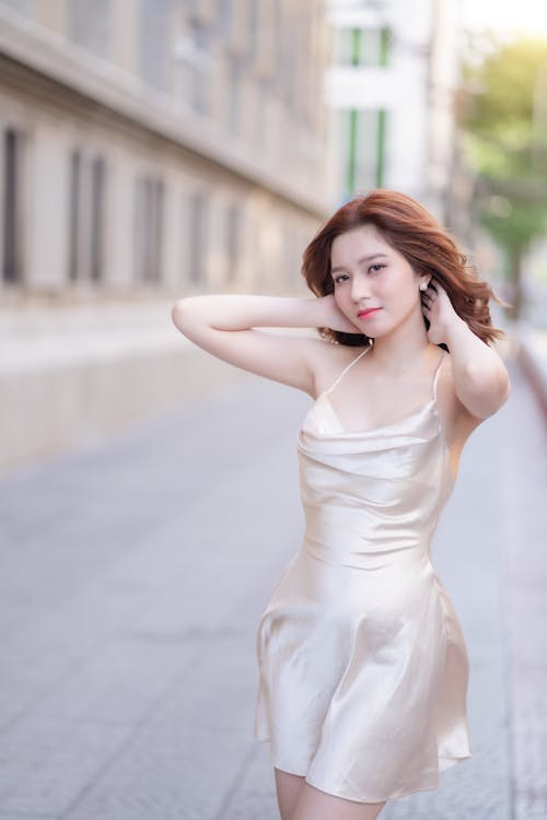 A woman in a short dress posing on the street