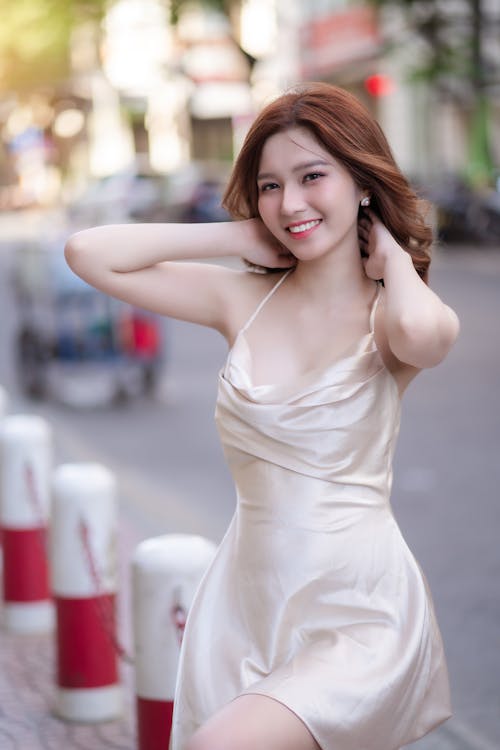 A beautiful young woman in a short dress posing for the camera
