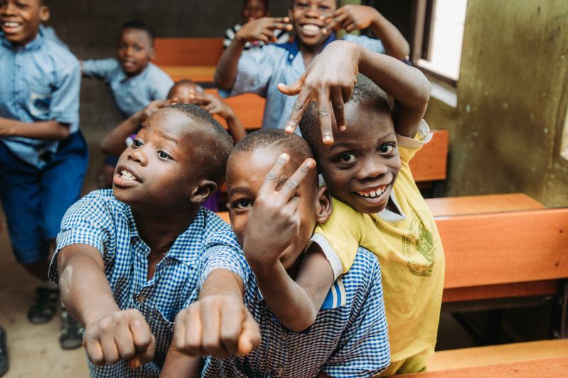 Boys smiling in an indoor classroom setting