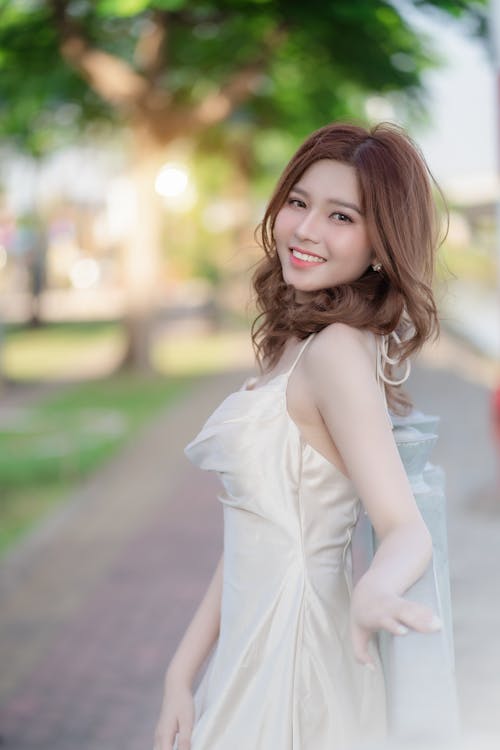 A beautiful asian woman in a white dress