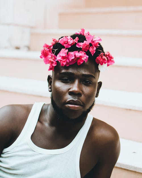 Man Wearing White Tank Top With Floral Headdress