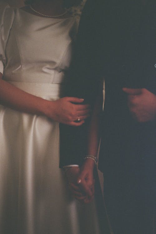 A bride and groom holding hands in a wedding photo