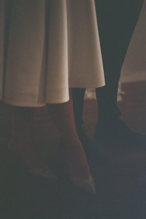 Legs of Woman in White Dress