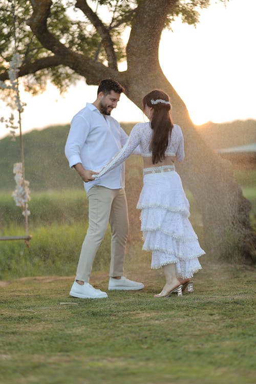 Couple Standing Together in White Dress and Shirt