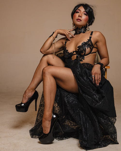 A woman in black lingerie sitting on a chair