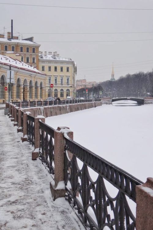 Free Snow-covered sidewalk alongside a frozen river in Saint Petersburg, Russia. Stock Photo
