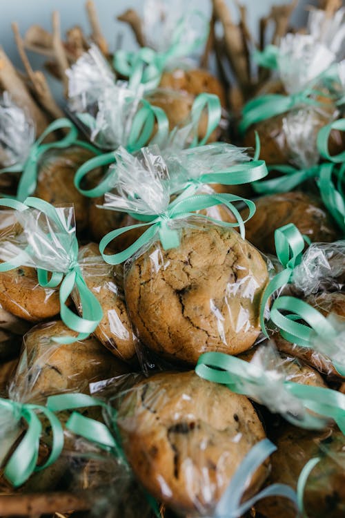 A basket filled with cookies and green ribbons