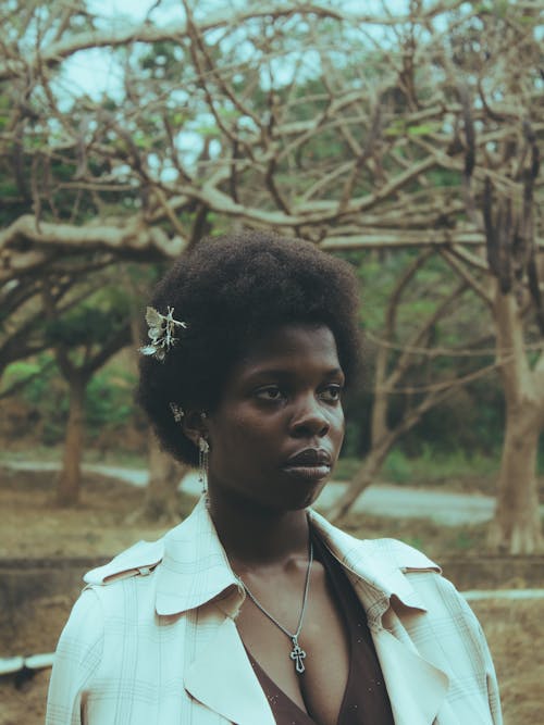 Young Woman Standing in a Park 