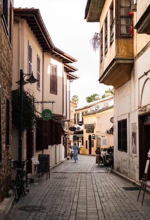 Free Explore the charming cobblestone streets of Antalya, Turkey's historic district, lined with quaint buildings and cafes. Stock Photo