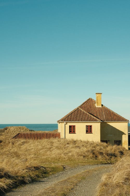 A house on the beach with a path leading to it