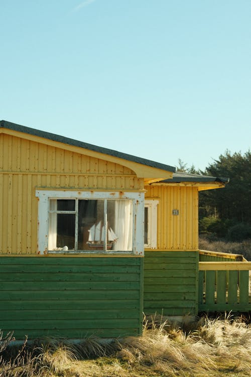 A yellow and green house