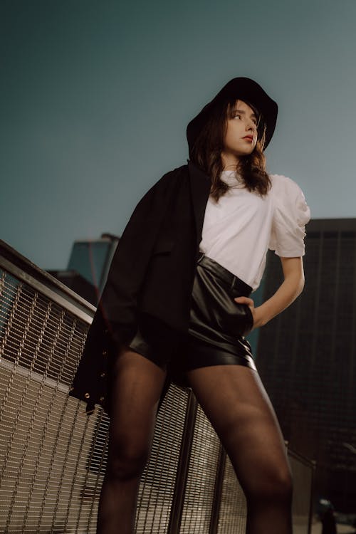 Woman Standing in Hat and with Suit Jacket