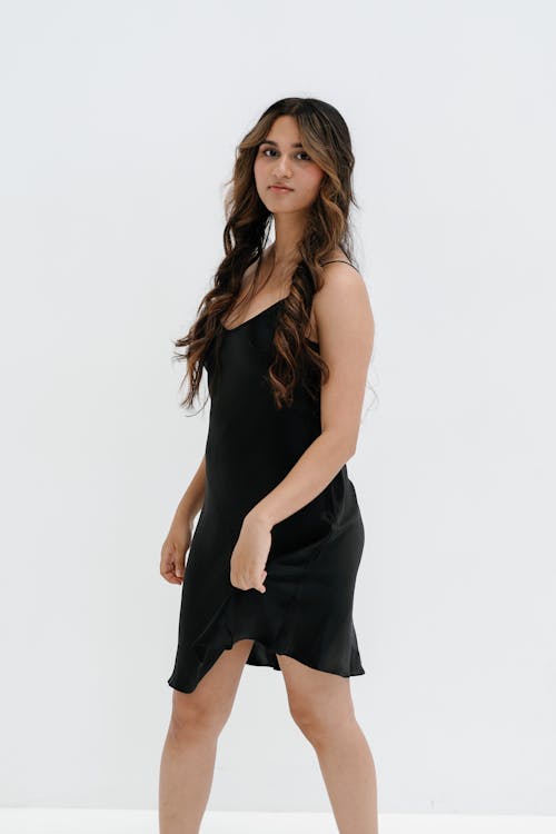A woman in a black dress posing for a photo