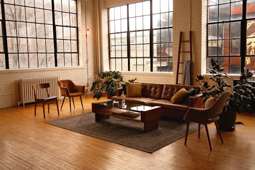 View of a Loft Style Living Room with a Brown, Leather Sofa 