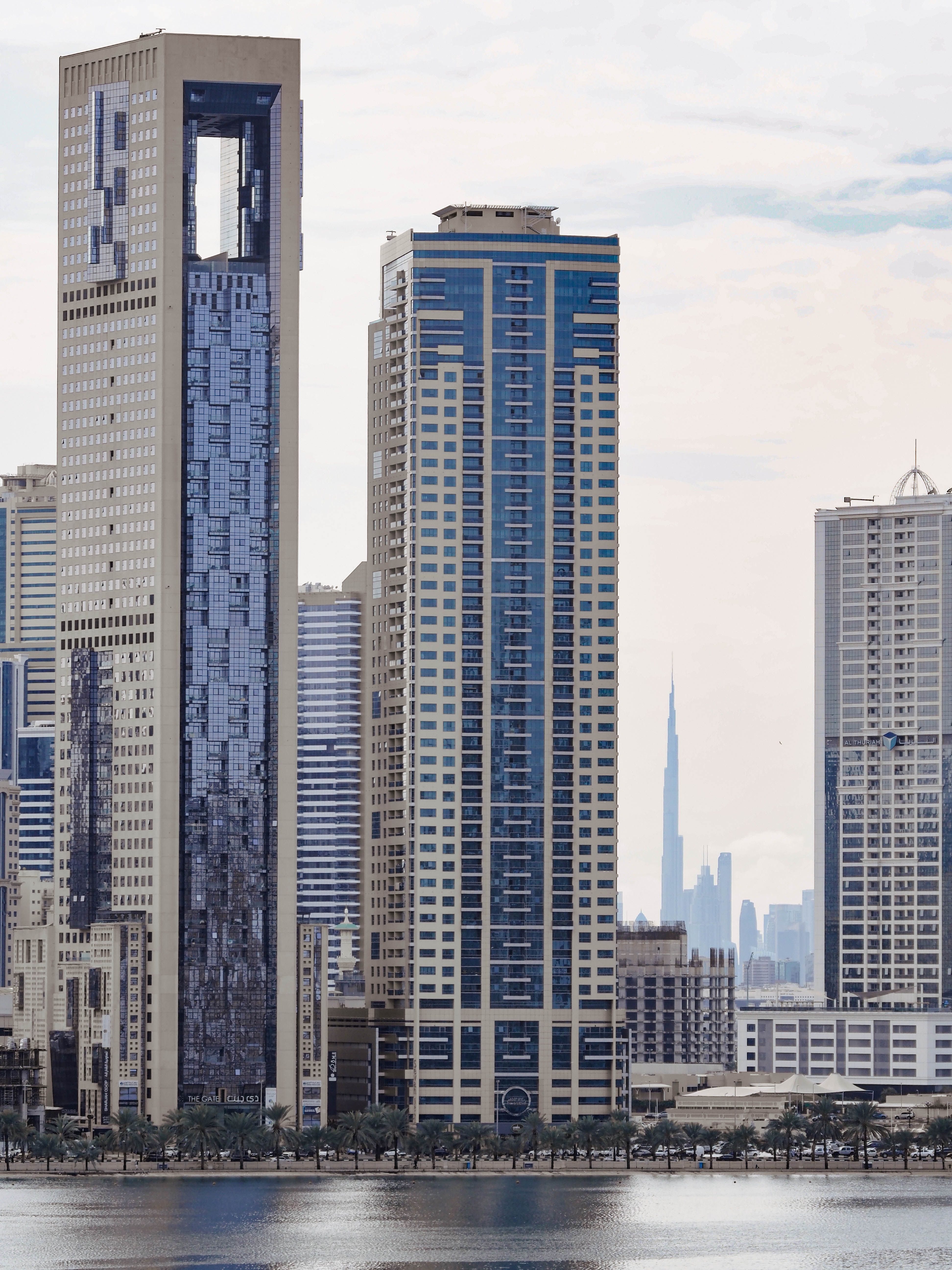 A stunning urban cityscape of Dubai with the iconic Burj Khalifa in view across the waterfront.