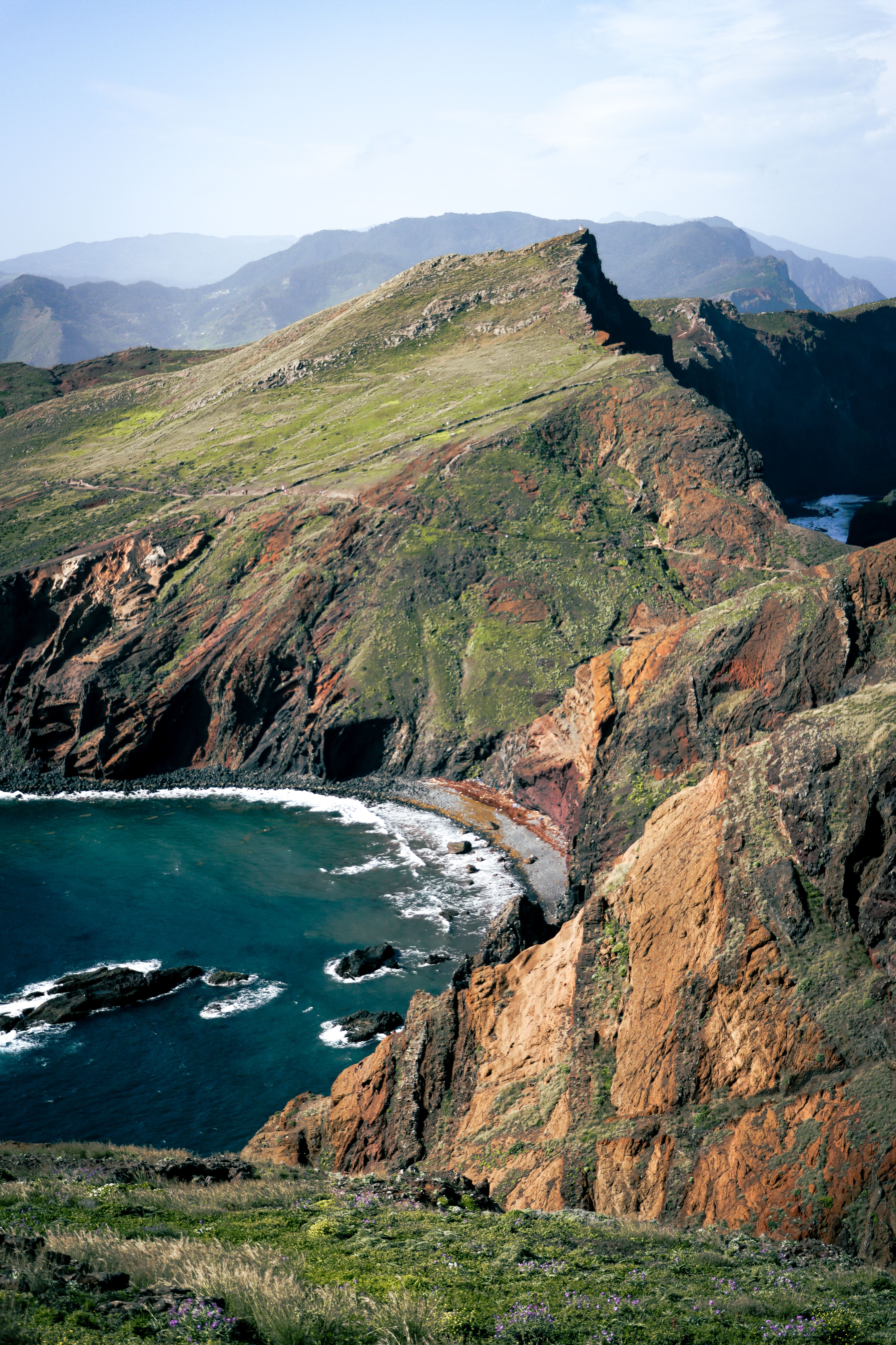 Breathtaking view of the rugged Madeiran coastline with mountains and sea, a natural and serene landscape.