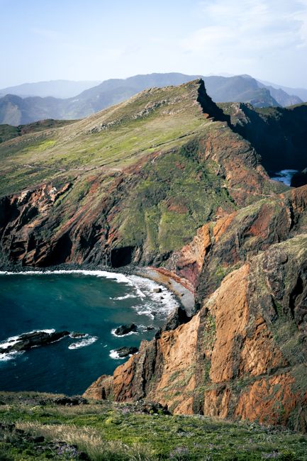 Breathtaking view of the rugged Madeiran coastline with mountains and sea, a natural and serene landscape.