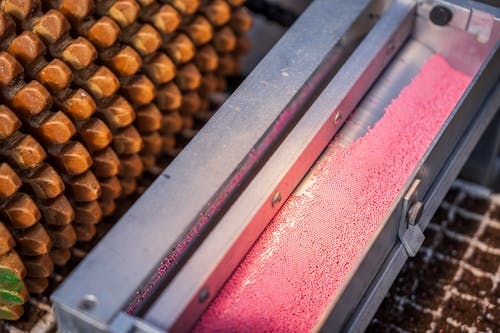 A machine that is making a pink substance