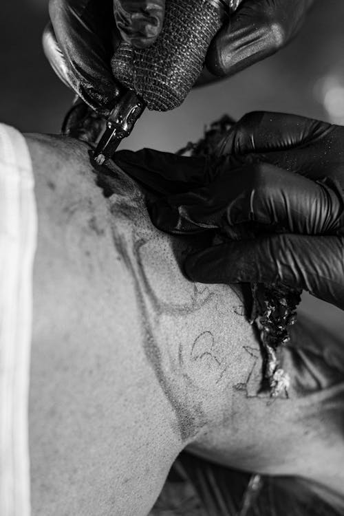 Close-up of a Tattoo Artist Tattooing a Persons Arm 