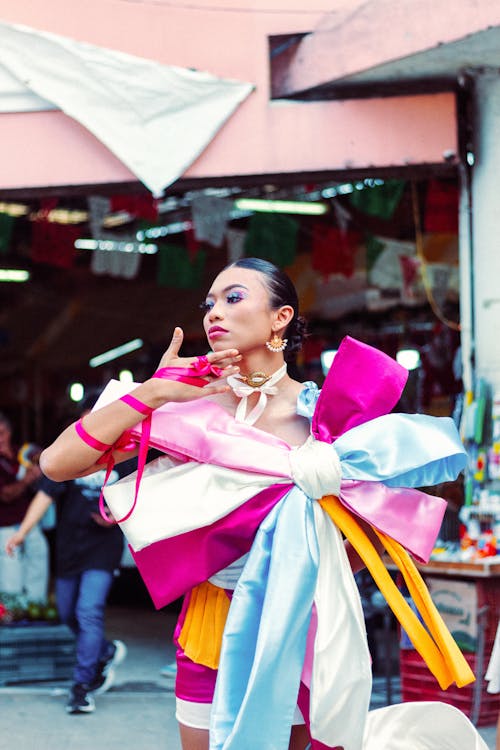 A woman in a colorful costume is walking down the street