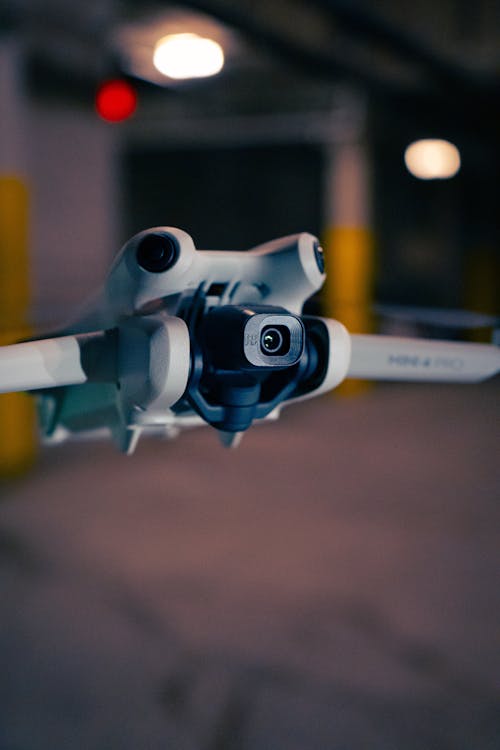 A close up of a small drone flying in the air