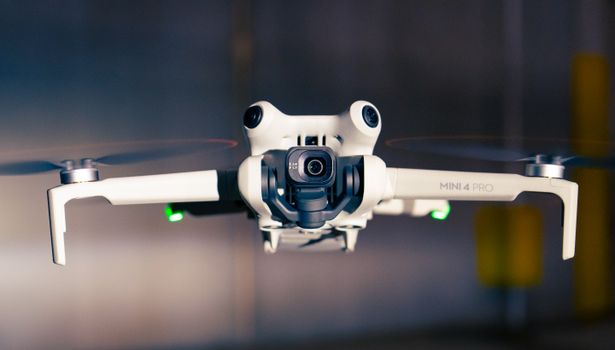 Close-up shot of a Mini 4 Pro drone hovering, showcasing advanced technology.