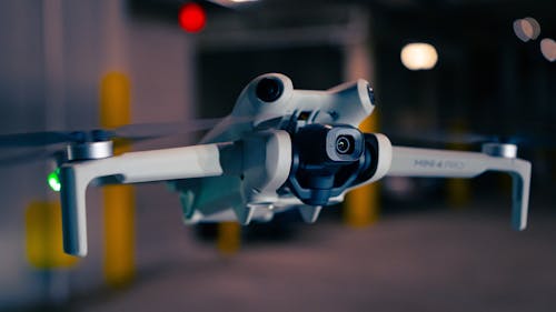 A close up of a small white drone