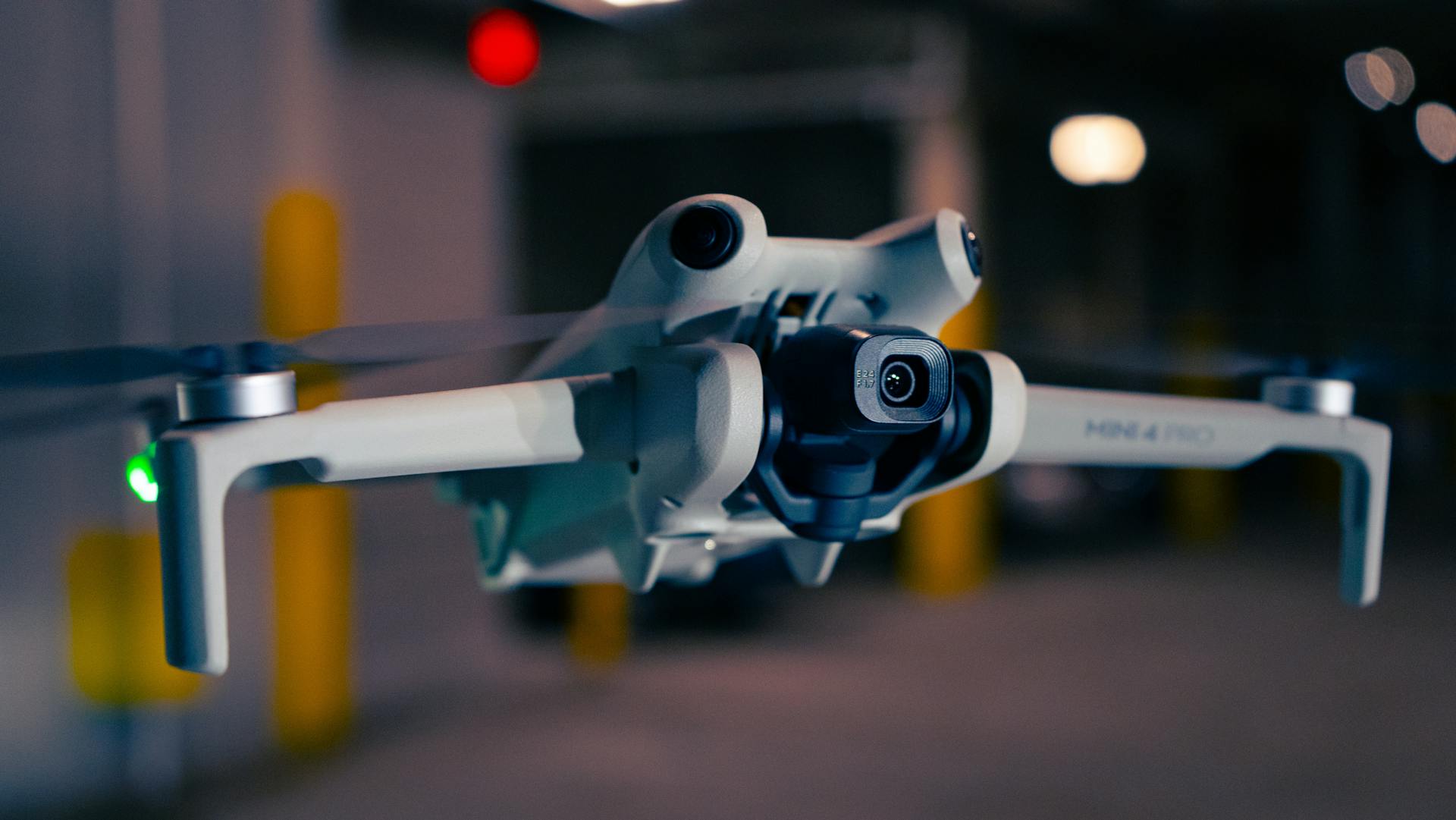 A close-up view of a modern drone flying indoors, showcasing advanced technology.