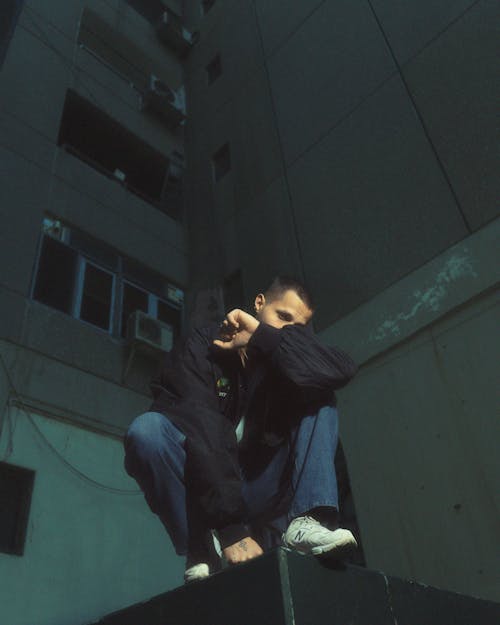 A man sitting on top of a building