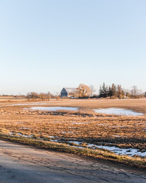 Free Beautiful autumn farm scene in Ontario, Canada, showcasing fields, a barn, and sunlight. Stock Photo