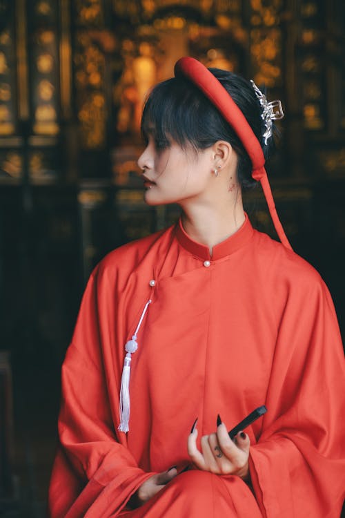 A woman in a red robe and hat