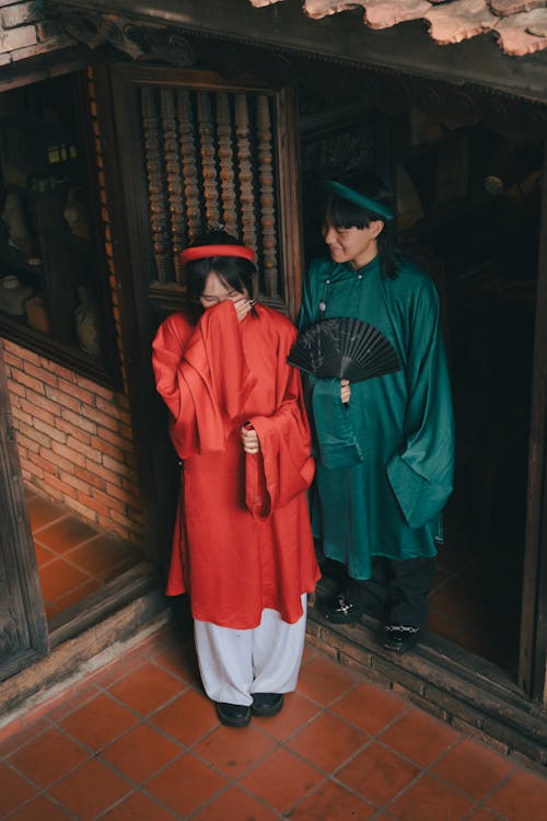 Women in Traditional Clothing and with Fan