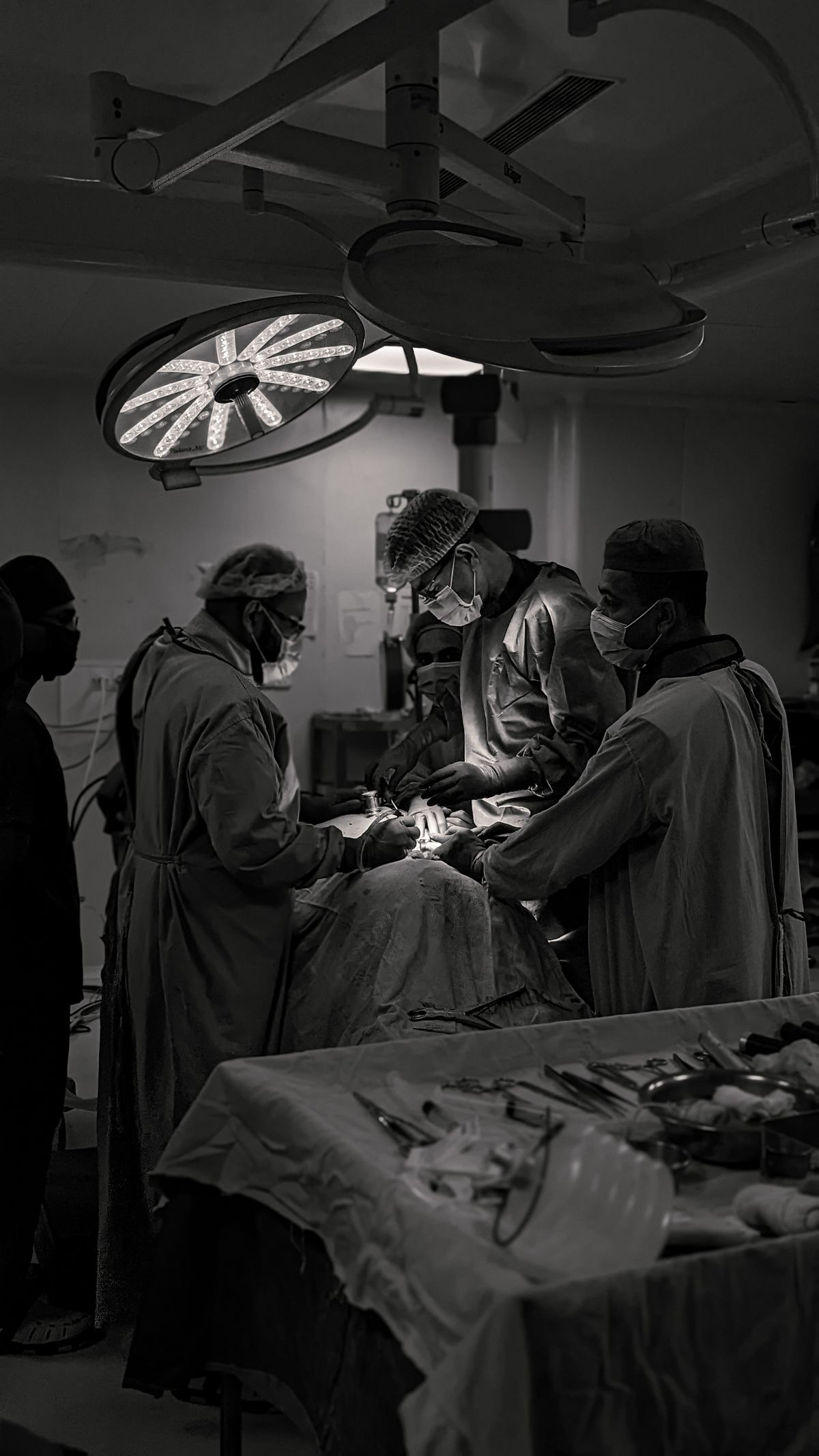 Surgical team performing an operation in an Indian hospital operating theatre