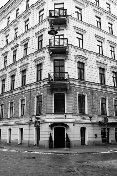 Free Black and white photo of a classic architectural building on a street corner in Riga, Latvia. Stock Photo