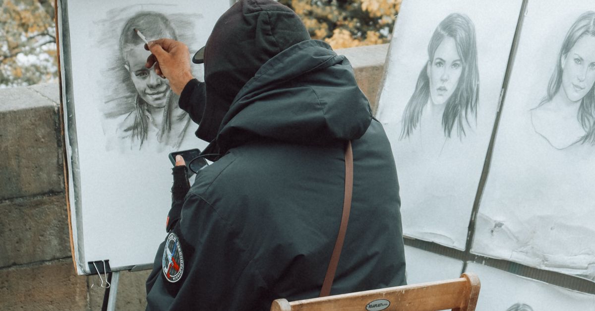 Portrait Back Back View of a Man Drawing Portraits on a Street · Free Stock Photo