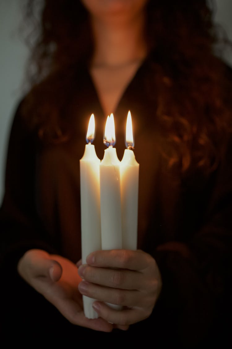 Woman Hands Holding Wax Candles